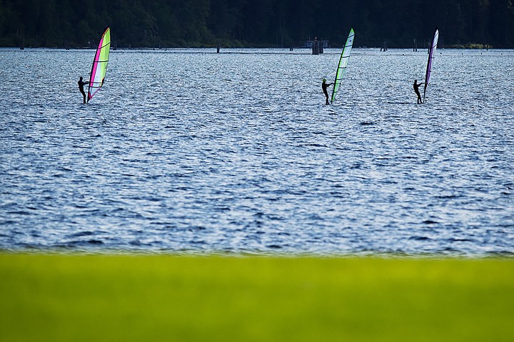 &lt;p&gt;SHAWN GUST Three windsurfers move across the choppy waters of Lake Coeur d'Alene on Monday afternoon.&lt;/p&gt;
