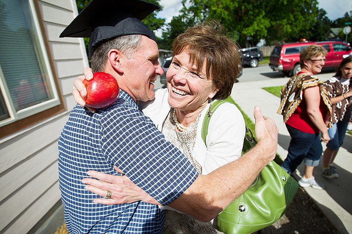 &lt;p&gt;SHAWN GUST Paula Conley, an educator at Canfield Middle School, hugs Vern Newby Monday during a retirement party at the Midtown Meeting Center in Coeur d'Alene. Newby, who, for more than 20 years, had made it a point to deliver an apple to each teacher in the district on the first day of school, was given an apple by Conley following the greeting.&lt;/p&gt;