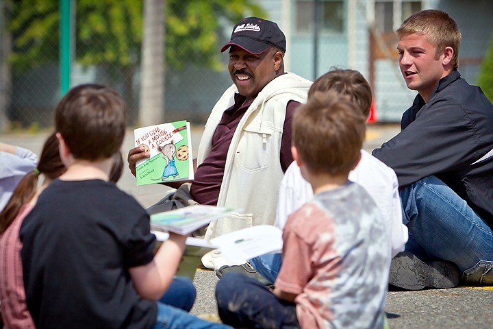 &lt;p&gt;JEROME A. POLLOS/Press Al Williams, left, athletic director for North Idaho College, and NIC wrestler Keri Stanley talk with first-grade students at Winton Elementary after reading them a book Monday. Wrestlers distributed the 7,000th book through the Shirley Parker Reading Program, a community service project that brings NIC&lt;/p&gt;