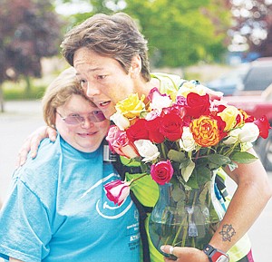 <p>Patrick Cote/Daily Inter Lake After finishing the final leg of her 91-mile fundraising run, Kelda Latham-Bennett, right, is greeted by Special Olympics athlete Chrissy Siefke in the Flathead Industries parking lot Monday afternoon. Latham-Bennett raised more than $4,000 for Special Olympics of Montana by running from Libby to Kalispell. The two-day run started Sunday at Achievements' Parkside Thrift Store in Libby and concluded Monday afternoon at Flathead Industries in Kalispell. Monday, June 4, 2012 in Kalispell, Montana.</p>