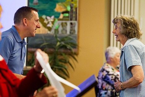 &lt;p&gt;Mark Goodwin, detective with the Post Falls Police Department, chats with Lois Olson Thursday following a presentation on internet fraud and charity scams during the 2012 Scam Jam at the Post Falls senior center.&lt;/p&gt;