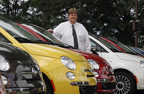 &lt;p&gt;James Tharp, sales manager at Fiat of South Atlanta in Morrow, Ga., poses with new Fiats on May 8. Back when gas was cheap, Americans bought cars with V-8 engines like the Big Block, Cobra Jet and Ramcharger, but now, thanks to government regulation and gas-price gyrations, the motors that move the nation's cars and trucks are shrinking.&lt;/p&gt;