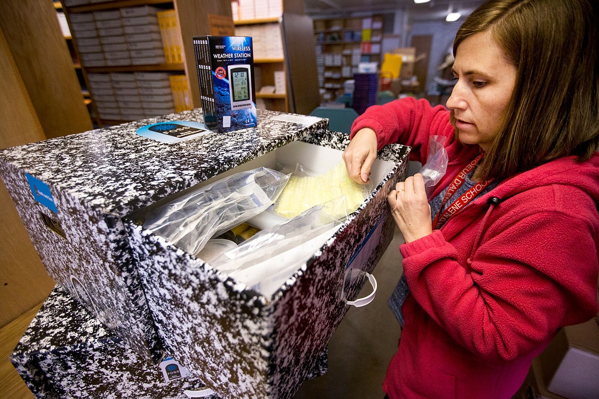 &lt;p&gt;Nicole Olson, curriculum and assessment assistant for the Coeur d'Alene School District, looks through a box on Tuesday containing investigation-based learning materials for a Earth and Sun science segment. The new materials will be implemented into a new science curriculum that will be taught in all grades all Coeur d'Alene public schools next school year.&lt;/p&gt;