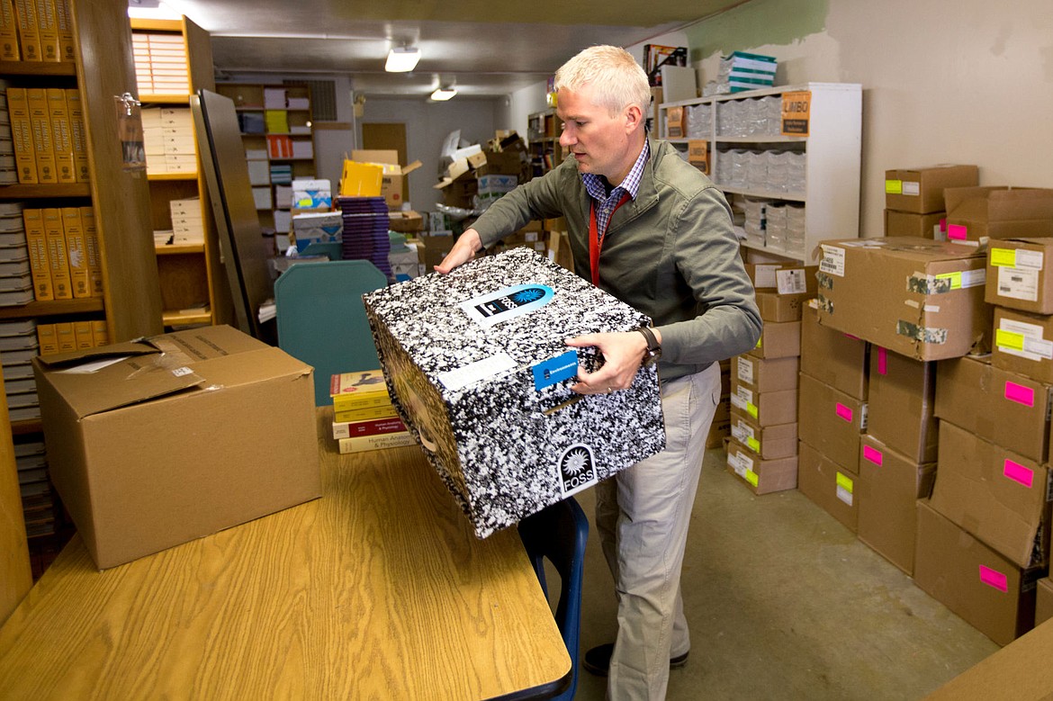 &lt;p&gt;Mike Nelson, director of curriculum and assessment for Coeur d'Alene School Distric, sets a box full of investigative learning materials on a table on Tuesday in the district's warehouse for new and unused learning materials.&lt;/p&gt;