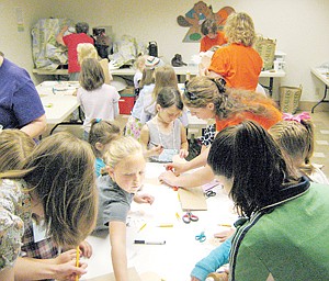 &lt;p&gt;Volunteers help fourth grade girls cut out moose heads to glue on paper bags. The &#147;moose-bags&#148; were fitting with the week&#146;s theme of National Parks at Vacation Bible School, held at Libby Christian Church.&lt;/p&gt;