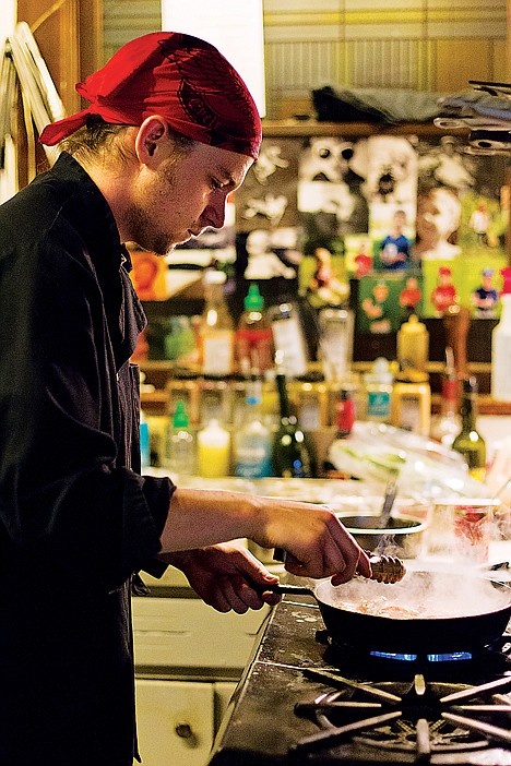 <p>Brandon Mitchell, sous chef at the Greenbriar Inn, prepares a daily special of seafood cazuela.</p>