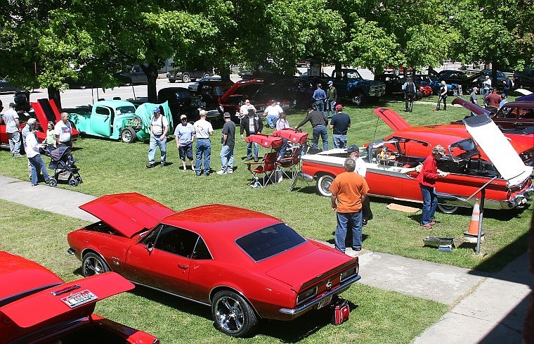 Passersby stop to enjoy the classic cars park in downtown Superior for the 12th annual car show Saturday afternoon.
