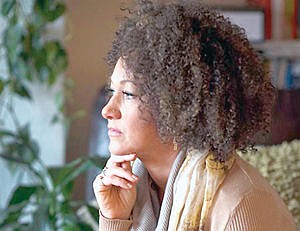 <p>FILE- In this March 2, 2015 file photo, Rachel Dolezal, president of the Spokane chapter of the NAACP, poses for a photo in her Spokane, Wash. home. Dolezal is facing questions about whether she lied about her racial identity, with her family saying she is white but has portrayed herself as black, Friday, June 12, 2015. (Colin Mulvany/The Spokesman-Review via AP, File) COEUR D'ALENE PRESS OUT</p>