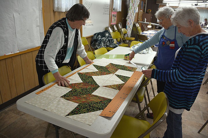 &lt;p&gt;Mary Ann Keast, Barbara Warrington and Linda Schone piece out Shone's quilt top.&lt;/p&gt;