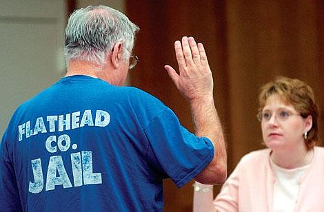 Chris Jordan/Daily Inter LakeDick Dasen Sr. is sworn in by Flathead County Court Clerk Pam Renfrow before testifying in Flathead County court Wedneseday morning in a hearing on a motion to release Dasen from jail. Dasen was denied the motion and will remain in jail until sentencing on July 18.