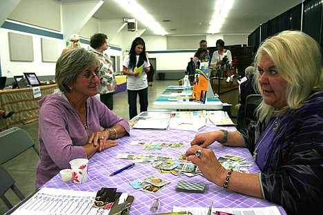 &lt;p&gt;Psychic Marsha Lord reads the future of Hayden resident Pamela Muno at the Holistic Fair on Saturday at the Kootenai County Fairgrounds.&lt;/p&gt;