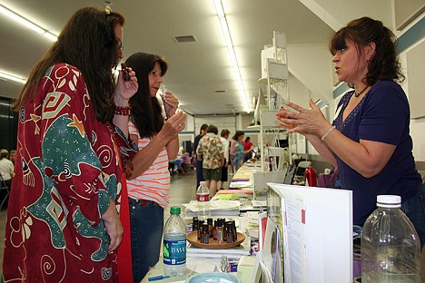 &lt;p&gt;Post Falls businesswoman Deb Perisian, right, discusses oils with Jeananh Jens, left, and Judi Calvert of Spokane at a holistic fair on Saturday at the Kootenai County Fairgrounds.&lt;/p&gt;