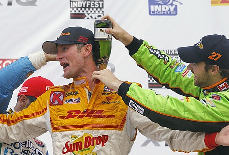 &lt;p&gt;Third-place finisher James Hinchliffe, right, and second-place Tony Kanaan, left, pour champagne down the back of winner Ryan Hunter-Reay after the IndyCar auto race at the Milwaukee Mile in West Allis, Wis., on Saturday.&lt;/p&gt;