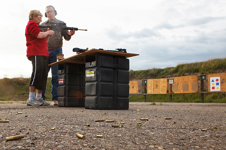 <p>Patrick Cote/Daily Inter Lake Sgt. Brad Stahlberg shows Marguerite Kaminski how to shoot his .22-conversion M4 rifle during range day at SheriffÕs CitizensÕ Academy. Thursday, May 17, 2012 in Kalispell, Montana.</p>