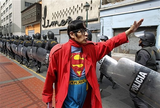 &lt;p&gt;In this photo taken June 13, 2012, Avelino Chavez, wearing his signature Superman costume, waves and greets riot police walking in formation toward a plaza where a protest is expected to take place in downtown Lima, Peru. Chavez, 52, took on the Superman persona 15 years ago, when he lost his job as a security guard, and says he has had work ever since. Chavez also says he only earns about $160 US dollars per month, but that he has the strength of a superhero. Chavez currently works to promote a travel agency. (AP Photo/Martin Mejia)&lt;/p&gt;