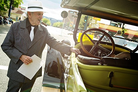 &lt;p&gt;Foster Manning, suited up in 1920's gangster pinstripes, talks to the passengers in his 1925 Dodge while waiting for the start of the Car d'Lane cruise.&lt;/p&gt;