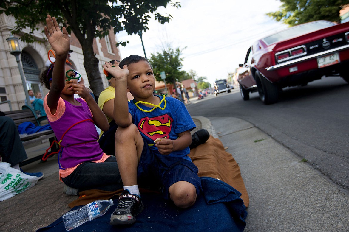 &lt;p&gt;Joy, 9, and her brother Gabriel Archuletta, 5, wave to classic cars, trucks and hot rods as they make their way down Fourth Street at the annual Car d'Lane.&lt;/p&gt;