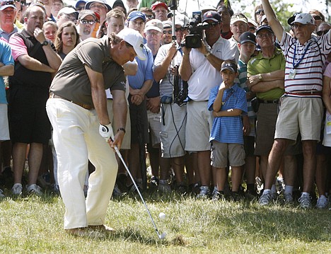 &lt;p&gt;Phil Mickelson hits from the rough along the 15th fairway during the second round of the U.S. Open Championship golf tournament in Bethesda, Md., Friday. Mickelson, at 1-over 143, sits 12 shots behind leader Rory McIlroy.&lt;/p&gt;