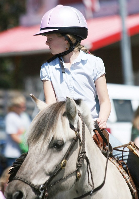 Morgan Beech rides down the street during the Plains Day parade in support of her mother, Nancy Beech who is running for public office.