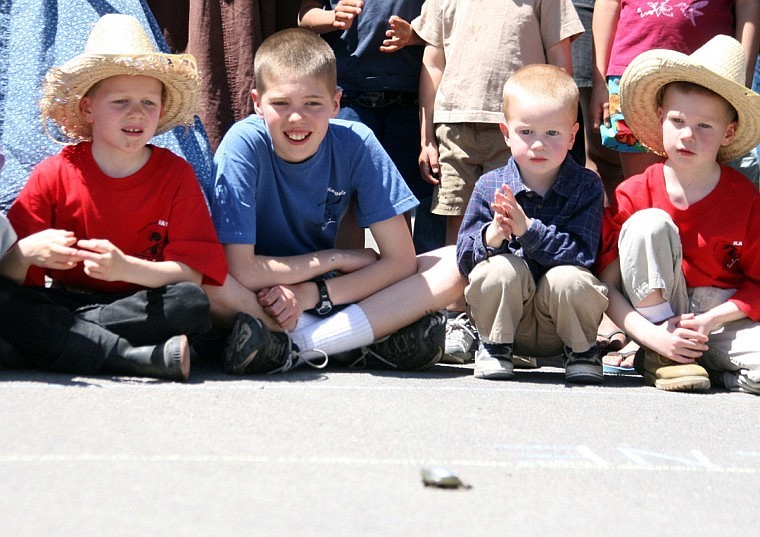 Several children watch the turtle races during Plains Day.