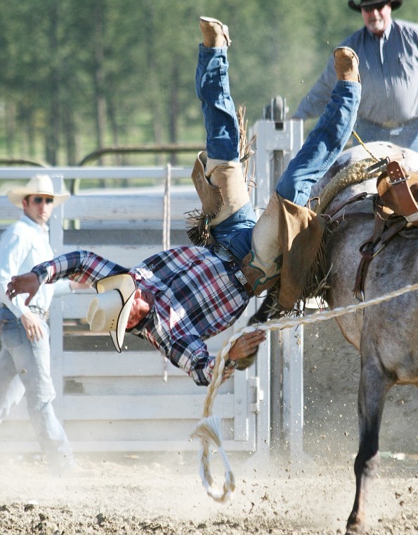 Doug Davis of Hot Springs takes a tumble in the saddle bronc riding competition on Saturday.