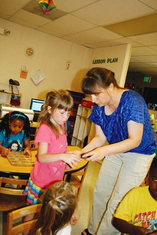 Daycare student Lyuda Burrich consults Lyubov Konovalchuk about a problem.