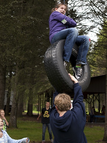 <p>First time camper, Brittany Staat of Kalispell, holds on tight as fellow campers push her on the tire swing at the Flathead CARE Kids Camp on Wednesday, June 13, in Bigfork. Staat, 13-years-old, says her favorite part of camp is getting to know the counselors and looks forward to getting the chance to be a counselor herself.</p>