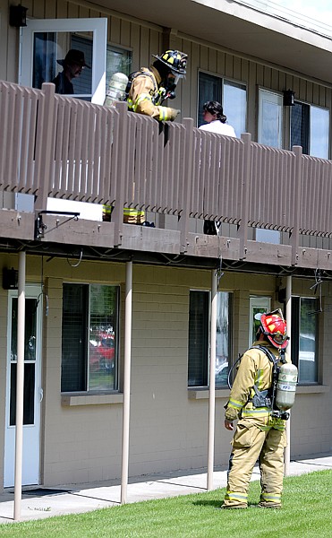 <p>Joe Hansen, above, and Captain Craig Fischer of the Kalispell Fire Department help evacuate residents following a gas leak were at Spruce Wood Apartments on Thursday afternoon, June 14, in Kalispell.</p>