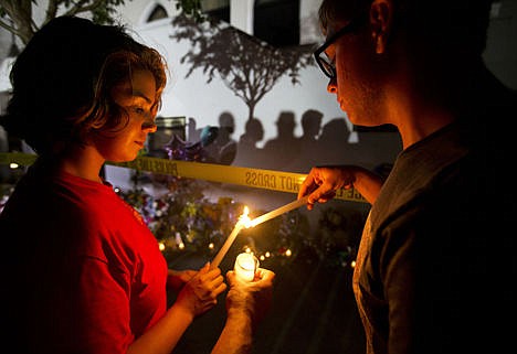 &lt;p&gt;Olina Ortega, left, and Austin Gibbs light candles at a sidewalk memorial in front of Emanuel AME Church where people were killed by a white gunman Wednesday during a prayer meeting inside the historic black church in Charleston, S.C., Thursday. Olina Ortega, left, and Austin Gibbs light candles at a sidewalk memorial in front of Emanuel AME Church where people were killed by a white gunman Wednesday during a prayer meeting inside the historic black church in Charleston, S.C., Thursday.&lt;/p&gt;