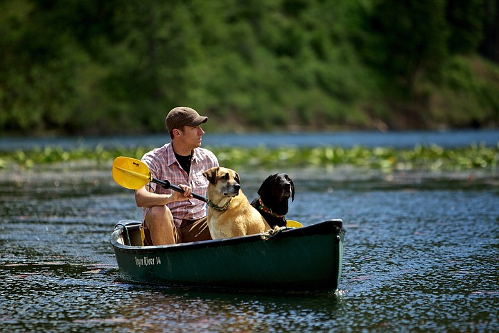 &lt;p&gt;JEROME A. POLLOS/Press David Spoelstra and his dogs Jiggs, right, and Huck canoe across Fernan Lake from their campsite to the dock at the east end of the lake Tuesday.&lt;/p&gt;