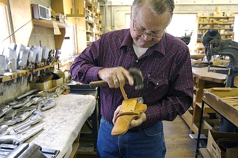 <p>Ben Wetzel, owner of the Idaho Leather Company in Boise, makes a holster on May 25. Wetzel's shop harkens to an era of hand-made and hand-crafted. Some of the machines in his shop date before 1900.</p>