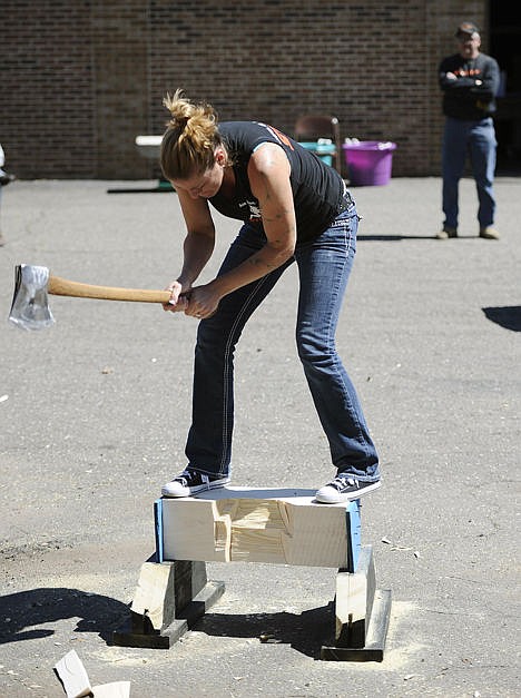 <p>Alissa Harper, founder of Axe Women of Maine, chops a block of wood during a demonstration in Vernon, Conn., to kick-off the group's season touring county fairs, motorcycle shows and music festivals across North America, April 25.</p>