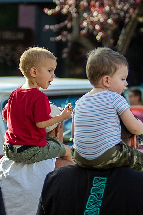 &lt;p&gt;Logan Cornelsen, left, (2) sits on top of his grandfather Larry Rubins shoulders while watching the classic car cruse during the Car d'Lane car show on Friday evening.&lt;/p&gt;