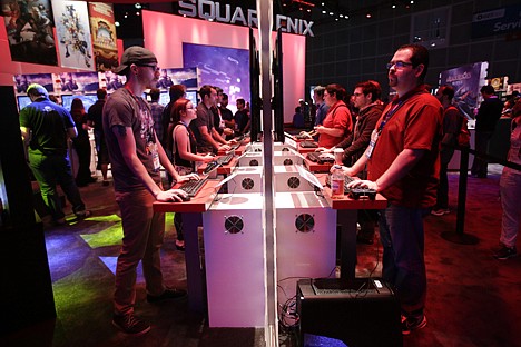 &lt;p&gt;People play a video game at the Square Enix booth at the Electronic Entertainment Expo, in Los Angeles. June 12.&lt;/p&gt;