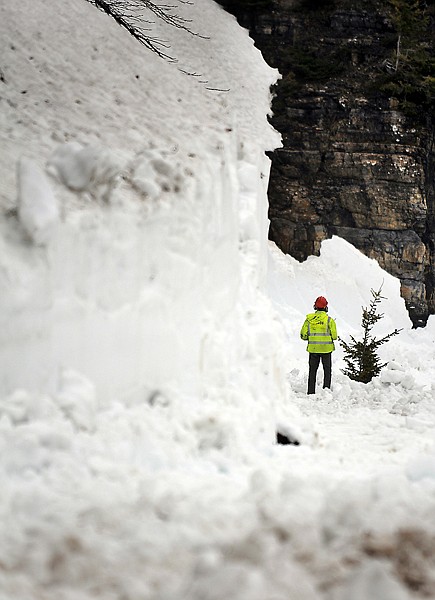 A member of the road crew surveys progress being made as workers clear snow from Sun Road on Wednesday in Glacier National Park. The park experienced an above-average winter and spring in terms of precipitation.
