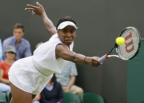 &lt;p&gt;Venus Williams of the US returns a shot to Uzbekistan's Akgul Amanmuradova at the All England Lawn Tennis Championships at Wimbledon, Monday.&lt;/p&gt;