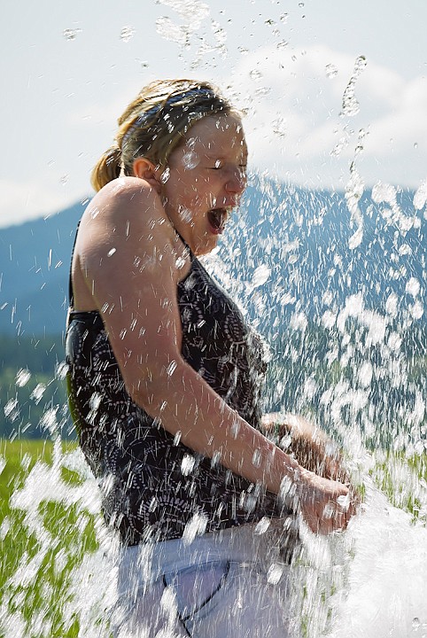 &lt;p&gt;SHAWN GUST/Press 12-year-old Emily Strong reacts as she is sprayed with water from a fountain at Independence Point Tuesday in downtown Coeur d'Alene.&lt;/p&gt;