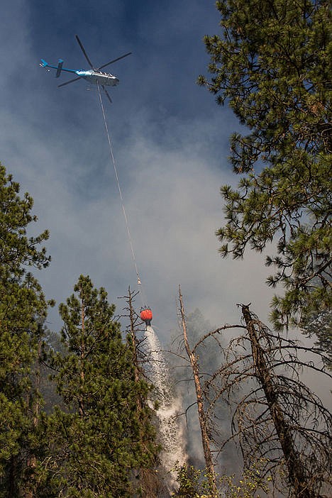 &lt;p&gt;A helicopter with a 200 gallon bucket brings water to pour along the north edge of the Tubbs Hill fire on Saturday evening.&lt;/p&gt;