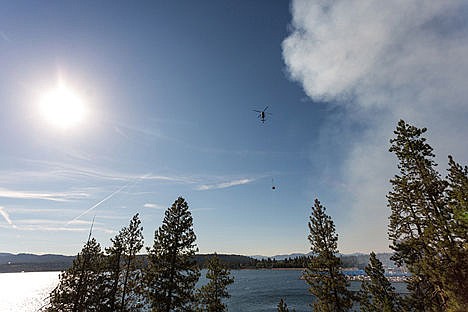 &lt;p&gt;A helicopter with a 200 gallon bucket brings water to pour along the north edge of the Tubbs Hill fire on Saturday evening.&lt;/p&gt;