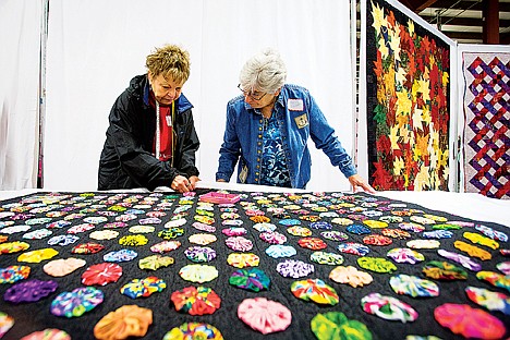 &lt;p&gt;Cheryl James, left, and Kay Stovern, with the North Idaho Quilters guild, prepare a quilt before hanging it Thursday while making preparations for the group's &quot;Quilted Gems&quot; show at the Kootenai County Fairgrounds.&lt;/p&gt;