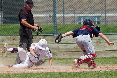 &lt;p&gt;Prairie's Derek Bumgarner slides safely into home plate, beating the tag from Tyler Earley, catcher for the Twin City Titans, in the third inning Thursday during the American Legion Best of the Northwest baseball tournament in Post Falls.&lt;/p&gt;