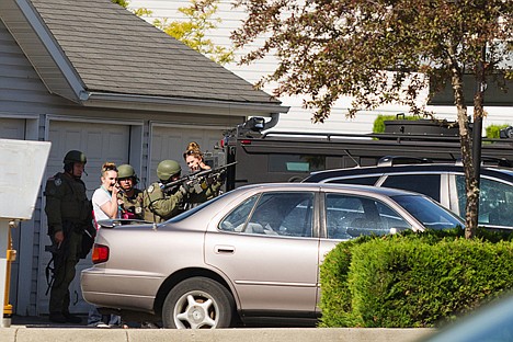 &lt;p&gt;Two females talk with Coeur d'Alene Police SWAT officers after exiting an apartment near another where an armed male was reported to be hiding Thursday at the Park Place Apartments.&lt;/p&gt;