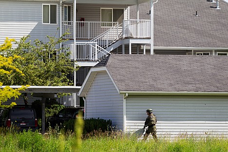 &lt;p&gt;Armed with an automatic rifle, a Coeur d'Alene Police Department SWAT team officer circles around a garage in front of the apartment of an male believed to armed with a rifle.&lt;/p&gt;