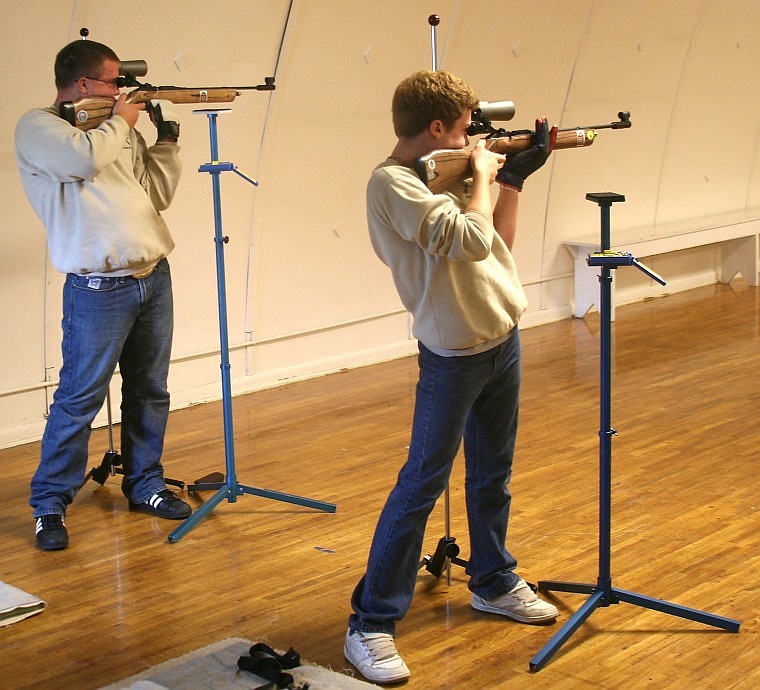 <p>Mineral County 4-H shooters Mackenzie "Spud" Crabb (left) and
Aidan Patko (right) set up for a shot during a practice in the
Superior 4-H building Saturday afternoon.</p>