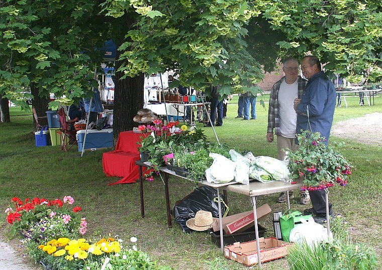 &lt;p&gt;Superior Fire Chief John Woodland (left) talks with St. Regis
resident Milton Pearce (right) Saturday afternoon during the
Superior Farmers Market.&lt;/p&gt;