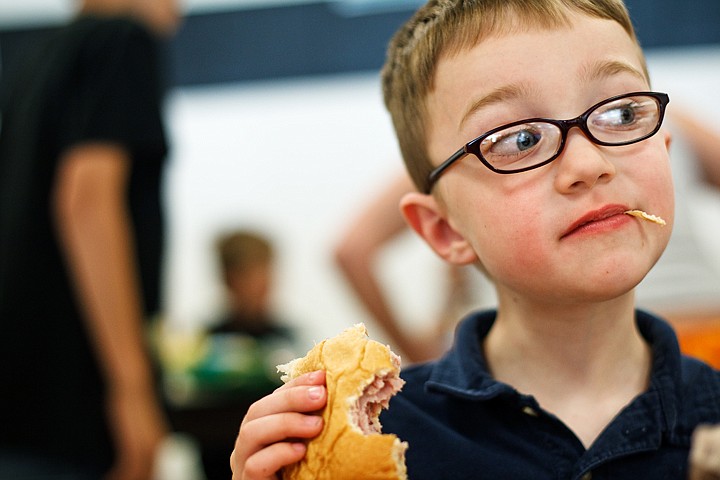 &lt;p&gt;Fischer Harris, 5, enjoys a sandwich Wednesday at Post Fall Middle School during a daily meal program. The cost of area school meal programs is expected to increase.&lt;/p&gt;