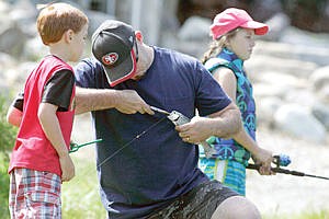 &lt;p&gt;Brysen Miller (7) left, Brendan Miller and Maura Miller (9). Brysen looks on as his father Brendan unhooks the fish he just caught during kids fishing day at the Troy fish pond.&lt;/p&gt;