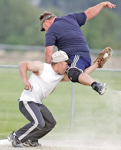 Paul Sievers/The Western News Third baseman Brandon Orr of Montana Machine puts the tag on Bill Bache of Treasure Mountain Casino-Libby Drug during coed softball action last Wednesday.