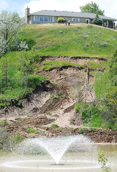 <p>Parts of the hillside above Village Greens in Kalispell slid into a pond below on Thursday morning.</p>