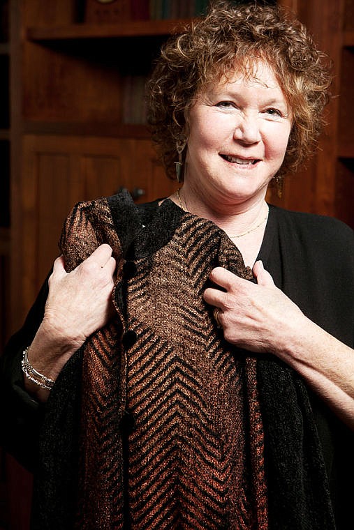 <p>Deb Newell holds one of her hand-painted pieces of clothing. June 16, 2014 in Lakeside, Montana. (Patrick Cote/Daily Inter Lake)</p>